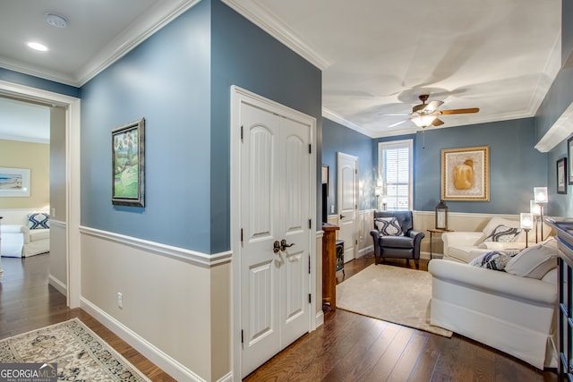 living room featuring crown molding, dark wood-type flooring, and ceiling fan