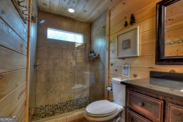 bathroom featuring vanity, an enclosed shower, toilet, and wooden walls