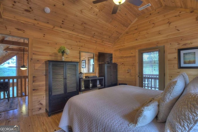 bedroom with hardwood / wood-style floors, lofted ceiling, wood walls, and wooden ceiling