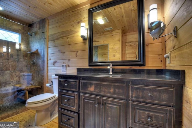 bathroom featuring wooden walls, vanity, wooden ceiling, hardwood / wood-style flooring, and toilet