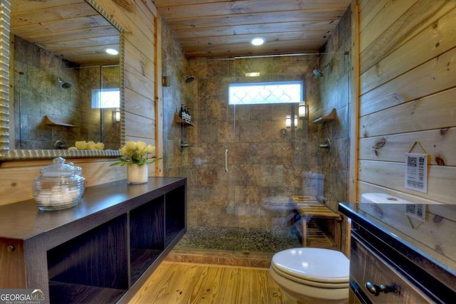 bathroom with a shower with shower door, toilet, wood-type flooring, vanity, and wood ceiling