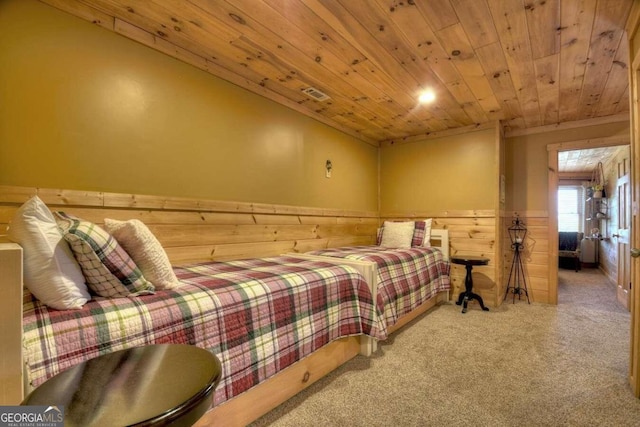 carpeted bedroom with wood ceiling