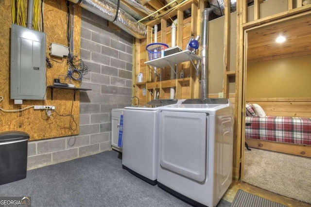 washroom featuring carpet flooring, brick wall, and washer and clothes dryer