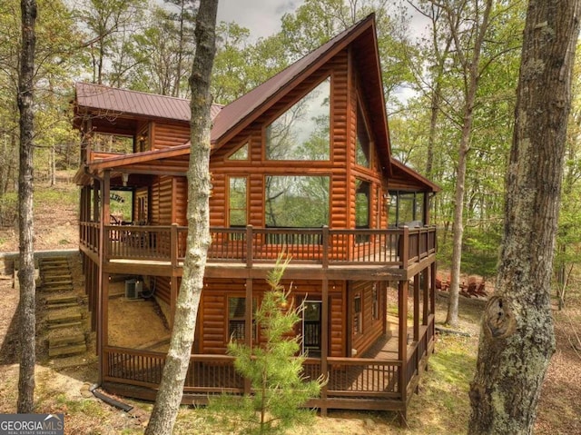 back of property with a wooden deck and central air condition unit