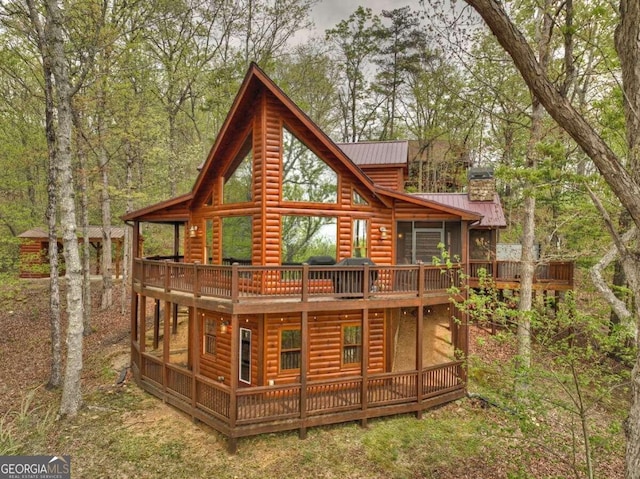 back of house featuring a deck