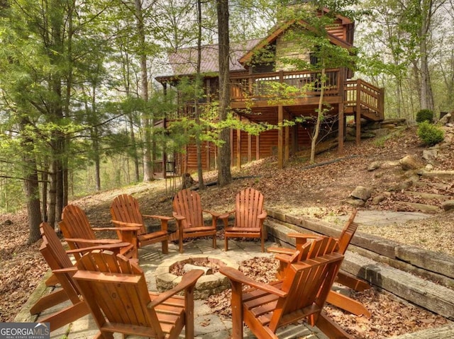 view of patio with a deck and a fire pit