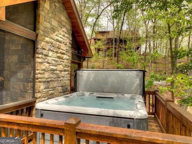 wooden deck featuring a covered hot tub