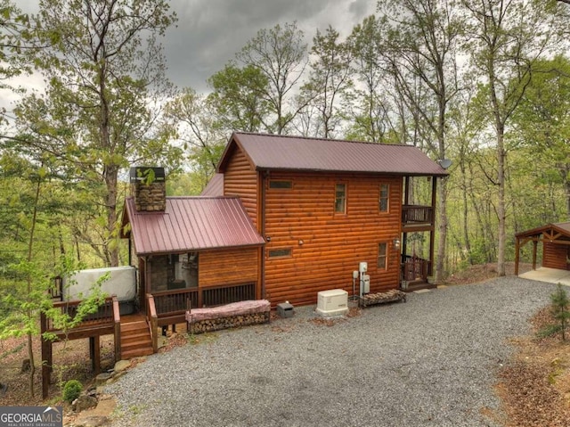 view of property exterior featuring a wooden deck