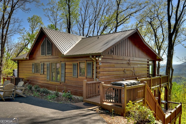 log cabin featuring a deck