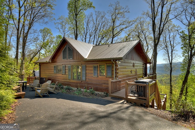 log cabin with a wooden deck