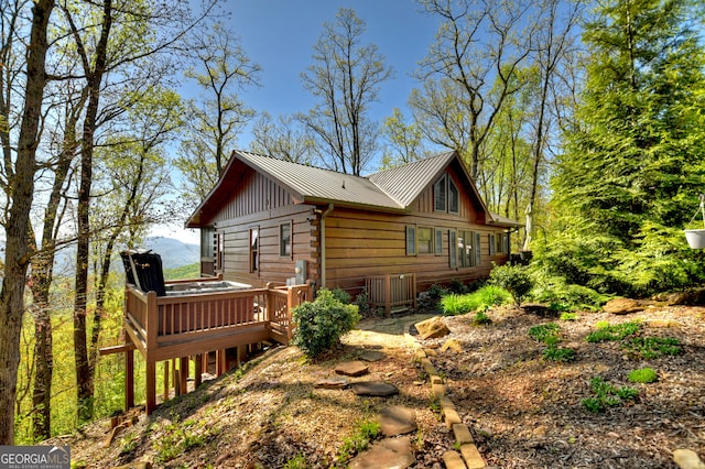 view of side of home with a deck