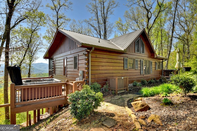 view of home's exterior featuring a deck with mountain view