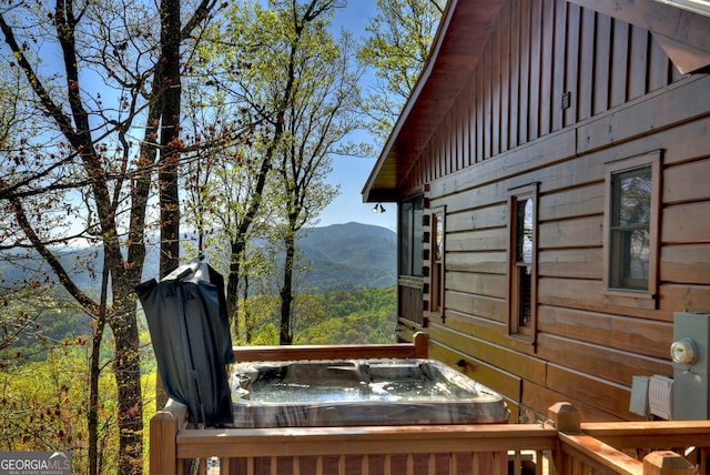 exterior space with a mountain view and a jacuzzi