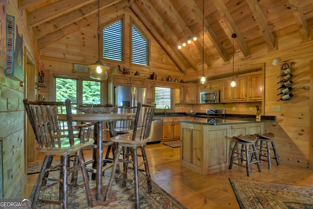 kitchen with wood walls, stainless steel appliances, and wooden ceiling