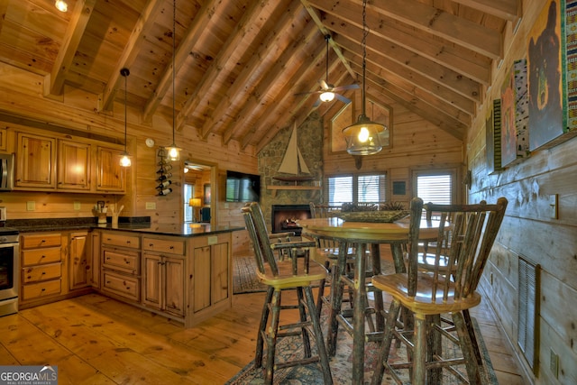 kitchen with wooden ceiling, light hardwood / wood-style flooring, beamed ceiling, and wooden walls