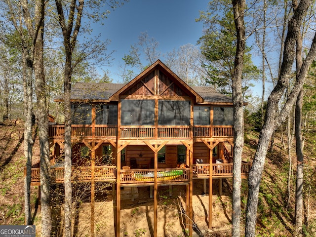 rear view of house featuring a deck