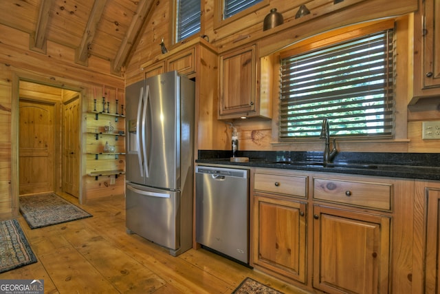 kitchen featuring wood ceiling, appliances with stainless steel finishes, vaulted ceiling with beams, and light wood-type flooring