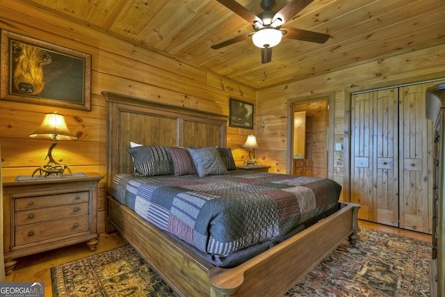 bedroom featuring wooden ceiling, wood walls, wood-type flooring, and ceiling fan