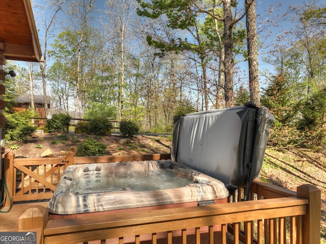 wooden terrace featuring a covered hot tub