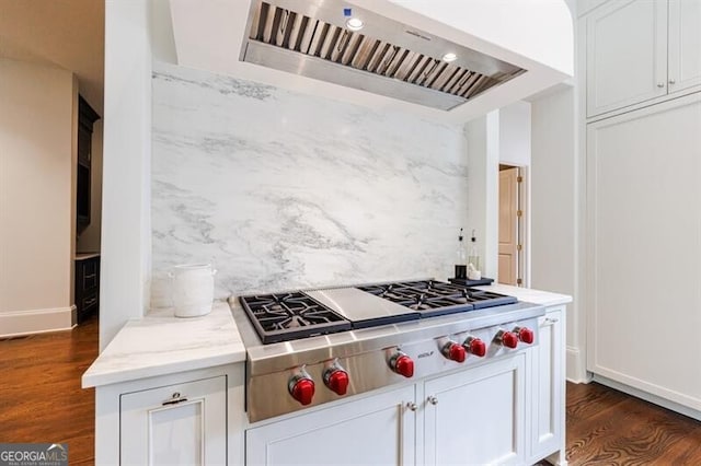 kitchen featuring white cabinetry, backsplash, stainless steel gas stovetop, dark wood-type flooring, and ventilation hood