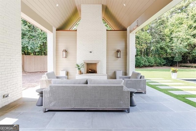 view of patio / terrace with an outdoor living space with a fireplace