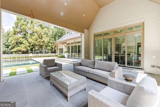 view of patio with a fenced in pool, an outdoor hangout area, and french doors