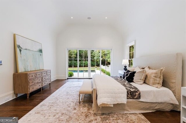 bedroom with dark wood-type flooring, high vaulted ceiling, and access to outside