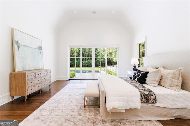 bedroom with dark wood-type flooring, access to exterior, and vaulted ceiling