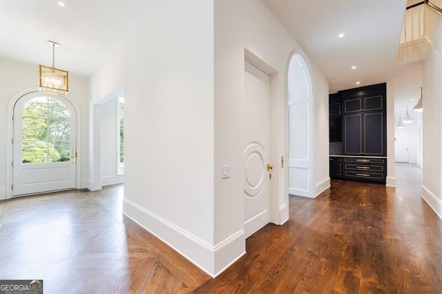 foyer entrance with a notable chandelier