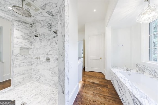 bathroom with separate shower and tub and wood-type flooring