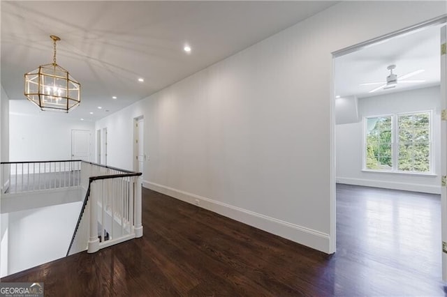 interior space with dark wood-type flooring and a chandelier