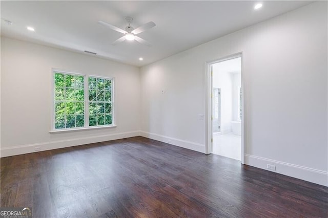 empty room featuring ceiling fan and dark hardwood / wood-style flooring