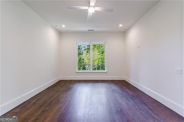 empty room with ceiling fan and dark hardwood / wood-style flooring