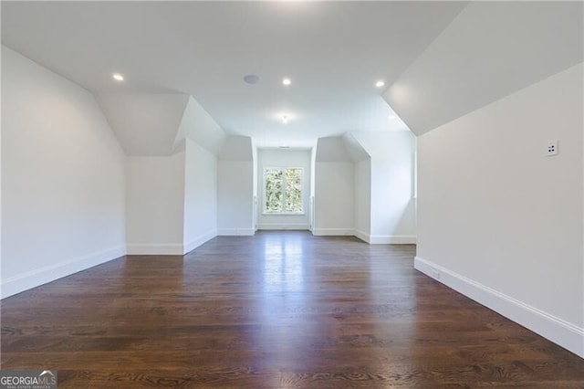 additional living space with lofted ceiling and dark hardwood / wood-style floors