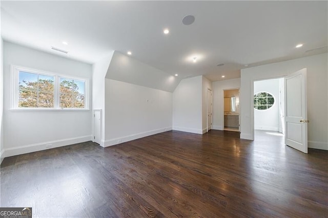 interior space with dark hardwood / wood-style flooring and lofted ceiling