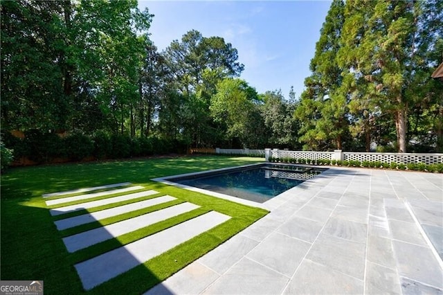 view of pool with a yard and a patio