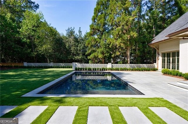 view of pool featuring a yard and a patio area