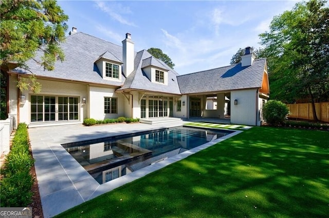 back of house with a yard and a patio area