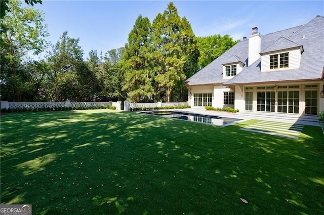 view of yard featuring a fenced in pool and a patio area