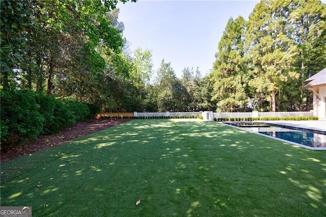 view of yard featuring a fenced in pool