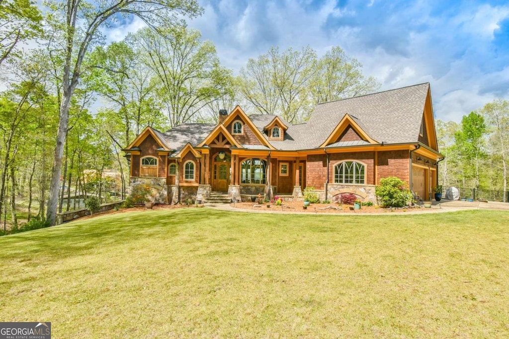 craftsman-style house with a front lawn and a garage