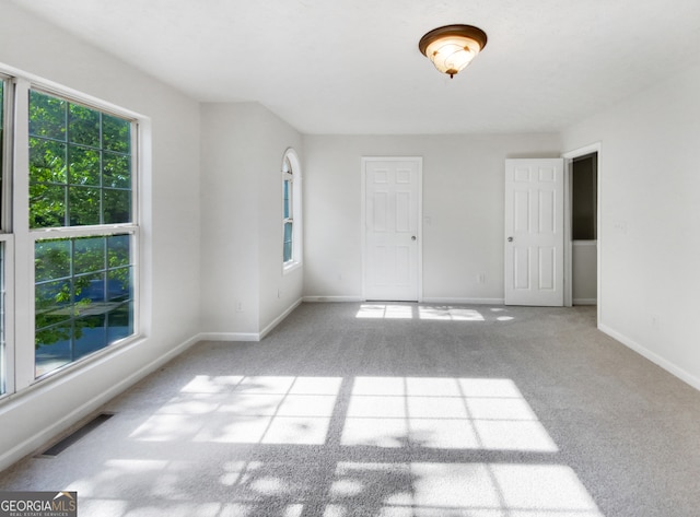 unfurnished room with light colored carpet