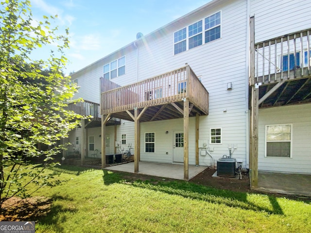 back of property with a yard, central air condition unit, and a patio area