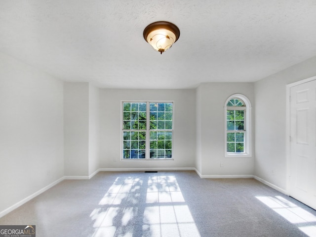 spare room featuring a textured ceiling