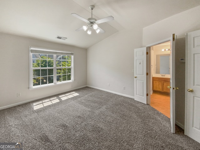 carpeted empty room featuring lofted ceiling and ceiling fan