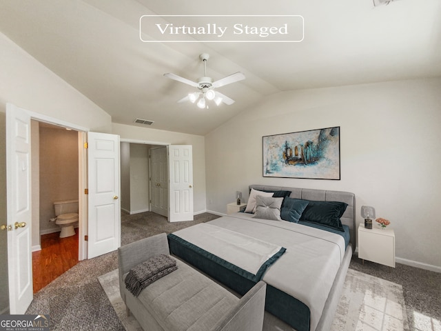 carpeted bedroom featuring vaulted ceiling, ceiling fan, and ensuite bathroom