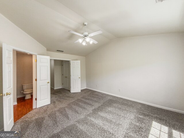 unfurnished bedroom featuring vaulted ceiling, ceiling fan, carpet, and ensuite bath