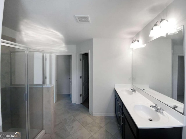 bathroom featuring walk in shower, double sink, oversized vanity, and tile flooring