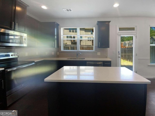 kitchen with dark brown cabinetry, sink, dishwasher, backsplash, and range with electric stovetop