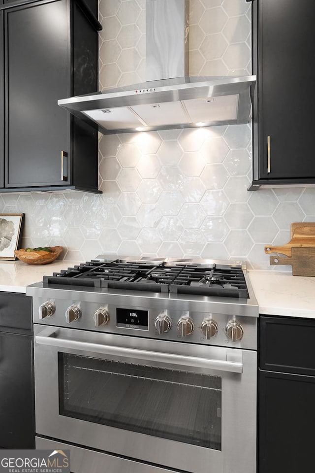 kitchen with tasteful backsplash, gas range, and wall chimney exhaust hood